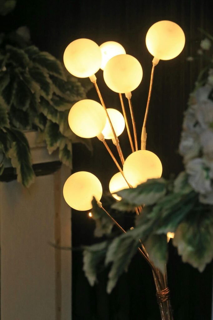 Stylish glowing lamps in a floral setting, perfect for modern interiors.